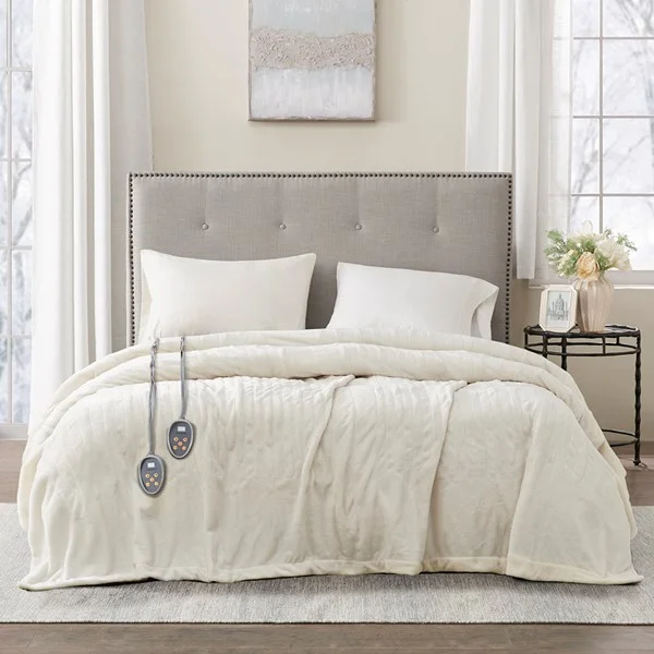 Ivory Beautyrest queen heated blanket spread over a bed with two separate controllers