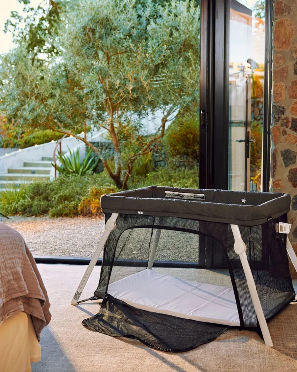 Guava Lotus travel crib with its side-access panel open