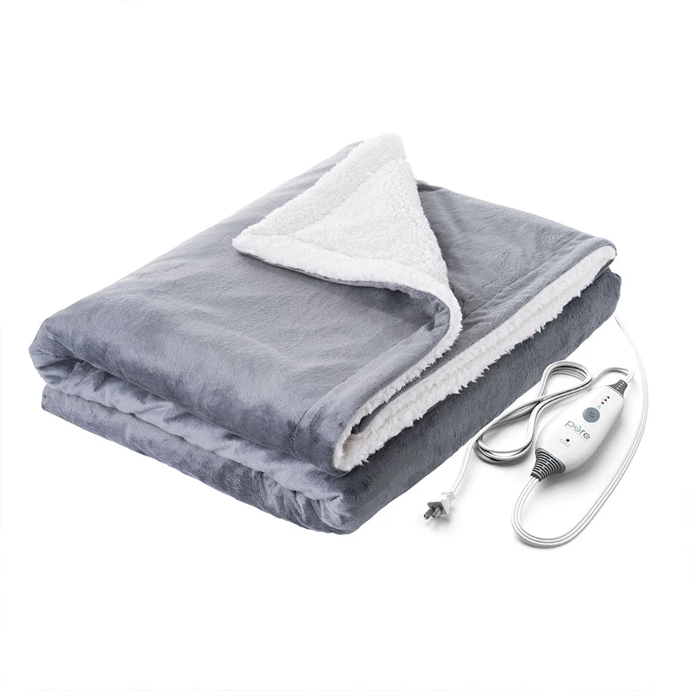 Gray PureRelief heated throw folded with its white sherpa backing and wired controller visible