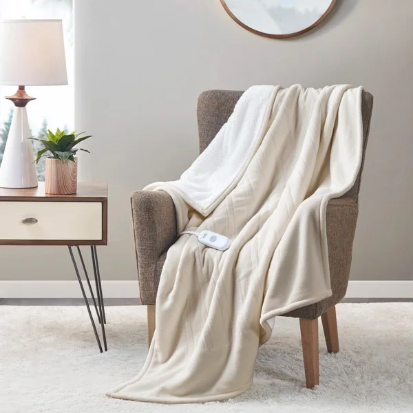 Tan Serta fleece-to-sherpa heated throw draped over a stationary chair